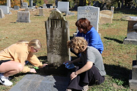 wesleyan students cleaning grave