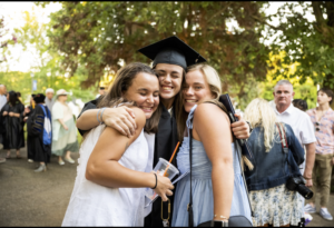 student embracing family at graduation