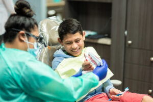 Dental hygienist smiling with a child