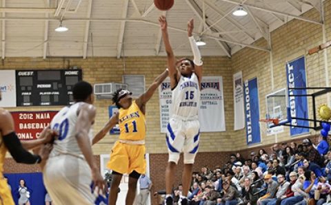 basketball player shoots the ball in Dwain Farmer gymnasium