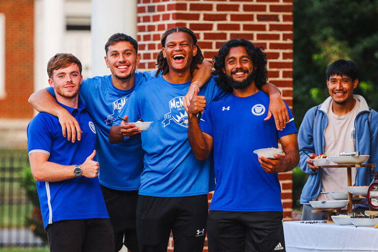 tennessee wesleyan soccer players in front of campus center