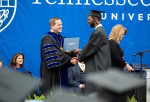 student receiving degree with Tyler Forrest