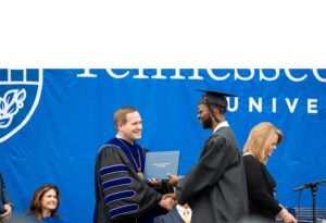 student receiving degree with Tyler Forrest
