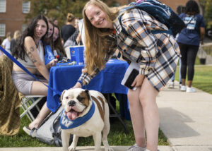 student at organization fair with wesley the bulldog