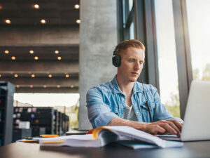 student studying in building with headphones