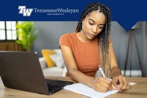 Student studying at Tennessee Wesleyan with graphic