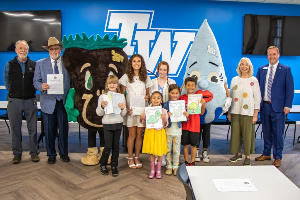 TWU and City of Athens pose for photo during the Tree Campus USA and Tree City USA presentation